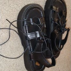 Chunky black platform sandals with classic gladiator-inspired straps