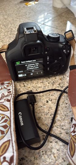 Canon EOS Rebel T100 DSLR camera with an EF-S 18-55mm f/3.5-5.6 III lens