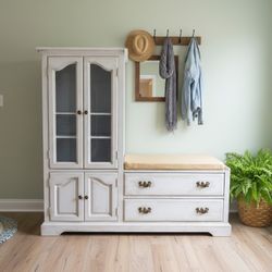 Custom refinished entryway storage bench with glass cabinet, drawers, and seating