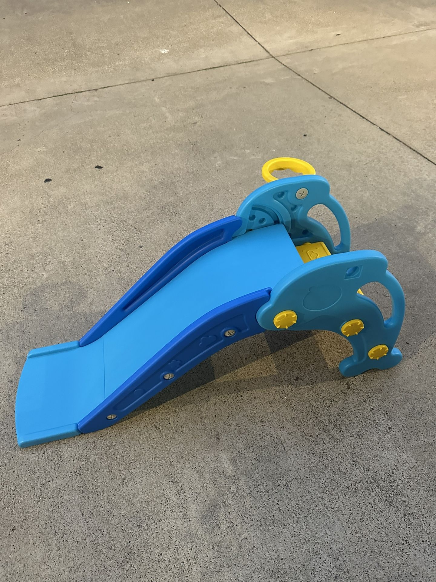 Brand new kids slide with basketball hoop and basketball