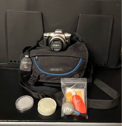 Minolta Maxxum GT 35mm film camera equipped with a silver zoom lens PLUS MORE