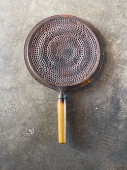vintage metal heat diffuser or "flame tamer" used for cooking on stovetops to distribute heat evenly and prevent burning