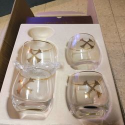 Bumbu Rum rocks glass with a gold crossbones logo and a gold rim. 