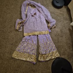 This lavender sharara suit, featuring a georgette kurti and matching flared pants with intricate gold sequin and mirror-style embroider$(100)obo