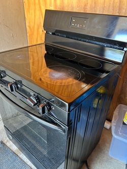 Estufa eléctrica 4 quemadores y horno , superficie de vidrio