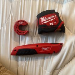 Milwaukee Measuring Tape with Milwaukee, box, cutter, and Milwaukee hand pipe cutter