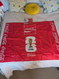 Coca-Cola World Cup 2026 flag with white Coca-Cola logo and FIFA World Cup trophy graphic