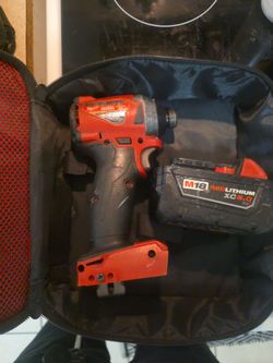 Milwaukee M18 cordless 1/4" hex impact driver with genuine M18 REDLITHIUM XC 5.0 battery.
