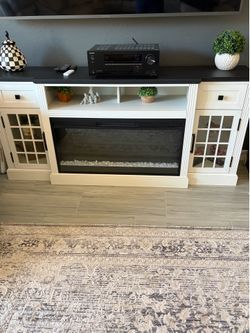 Entertainment center with electric fireplace.