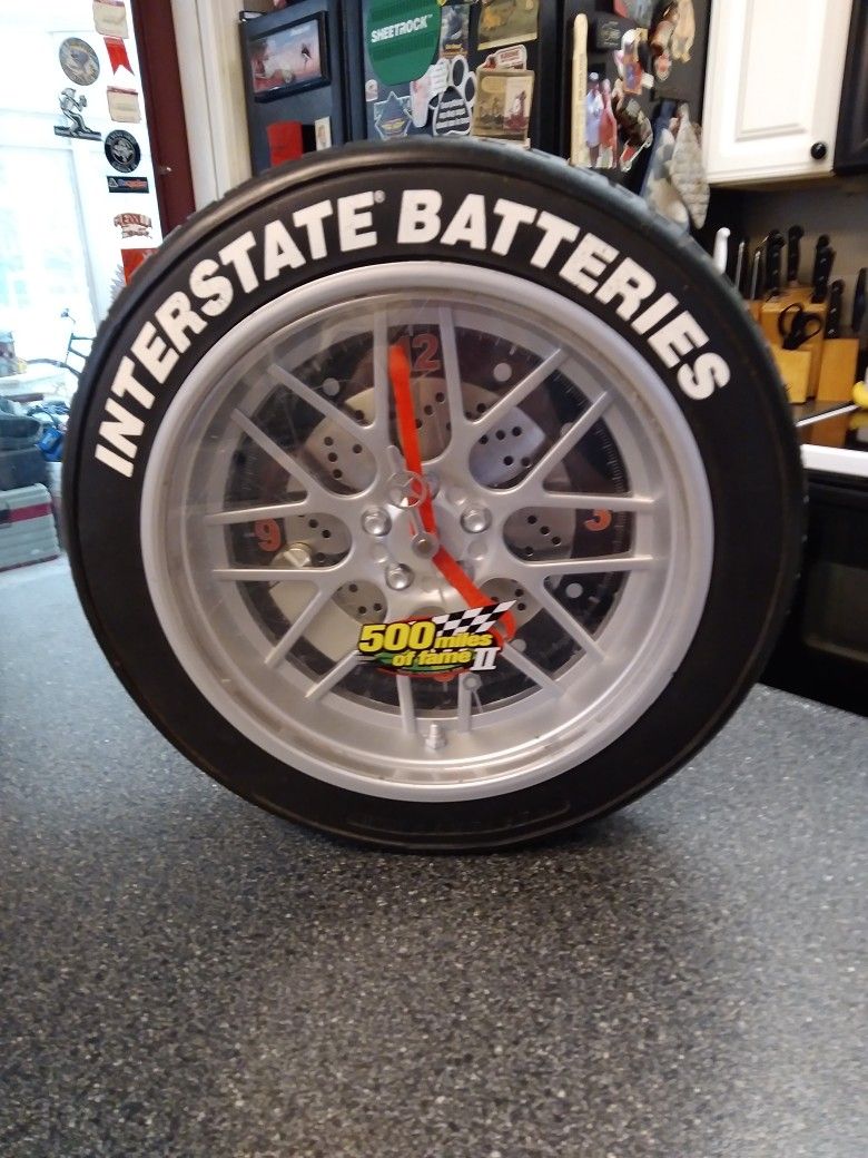 INTERSTATE BATTERIES. WALL CLOCK. 14 INCH. X. 3 INCH WIDE TIRE. KEEPS TIME