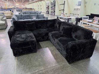 Black Jumbo corduroy sectional sofa with ottoman