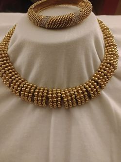 Gold tone bracelet and necklace set