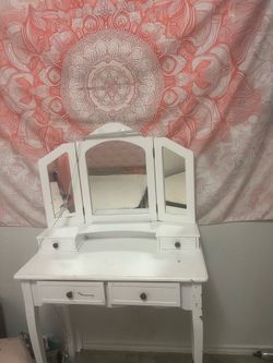White vanity, mirror, and deck