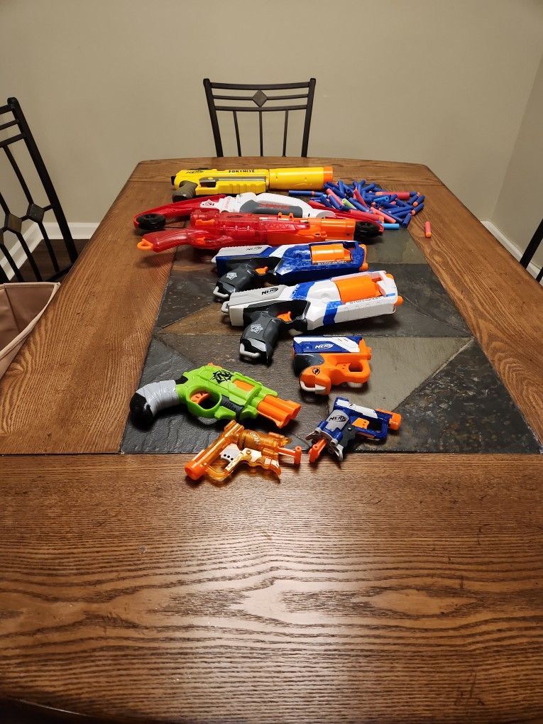 Assorted Nerf Guns with some darts