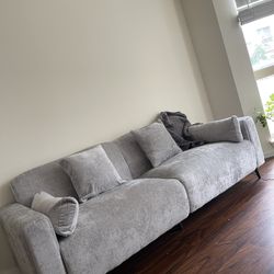 Grey Sectional Sofa With Pillow And Throw