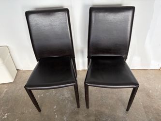 2 brown leather chairs