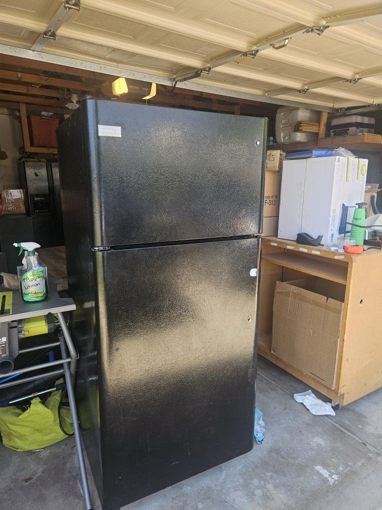 Medium Size Refrigerator. Black Outside.