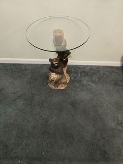 Black bear side table with glass top.