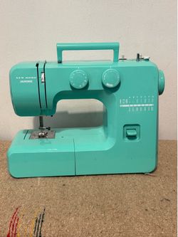 Janome Arctic Crystal sewing machine in a vibrant teal color.
