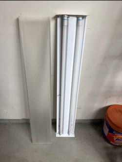 4-foot, 2-lamp fluorescent wraparound light fixture with a clear prismatic acrylic lens.