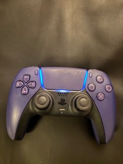 Blue PlayStation 5 controller with charging adapter
