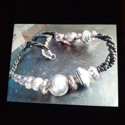 Gray Stones Around A Black Bracelet With Black Beads