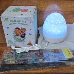Dinosaur Egg LED Night Light Projector, 360° Rotating Starry Sky with 12 Slides, White Noise