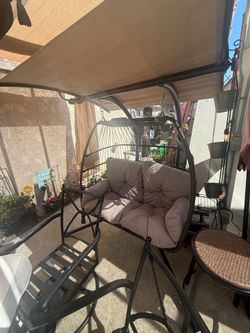 Swinging loveseat with canopy