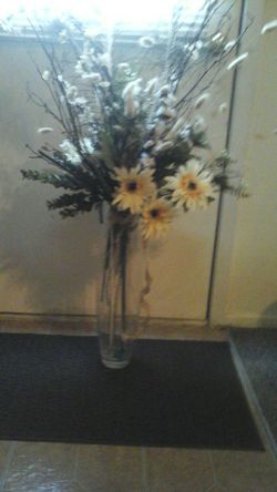 Beautiful flowers and peacock feathers in big glass vase would look beautiful on any table