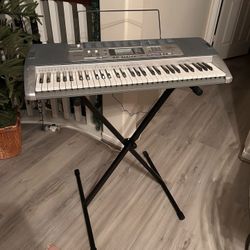 Casio LK100 Lighted Electronic Keyboard Piano with LCD Display - Stand & AC Adapter Included