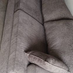 Brown dining table with 5 chairs and long sofa