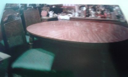 Table pecan with four chairs and one captain chair .
