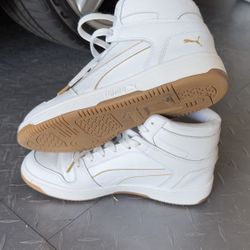 This is a pair of Puma SoftFoam+ high-top sneakers