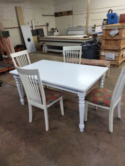 Table and 4 chairs and a bench