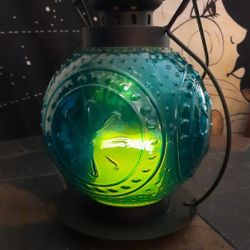 Pier 1 Vintage Candle Lantern The Glass Is Blue And The Frame Is Metal.