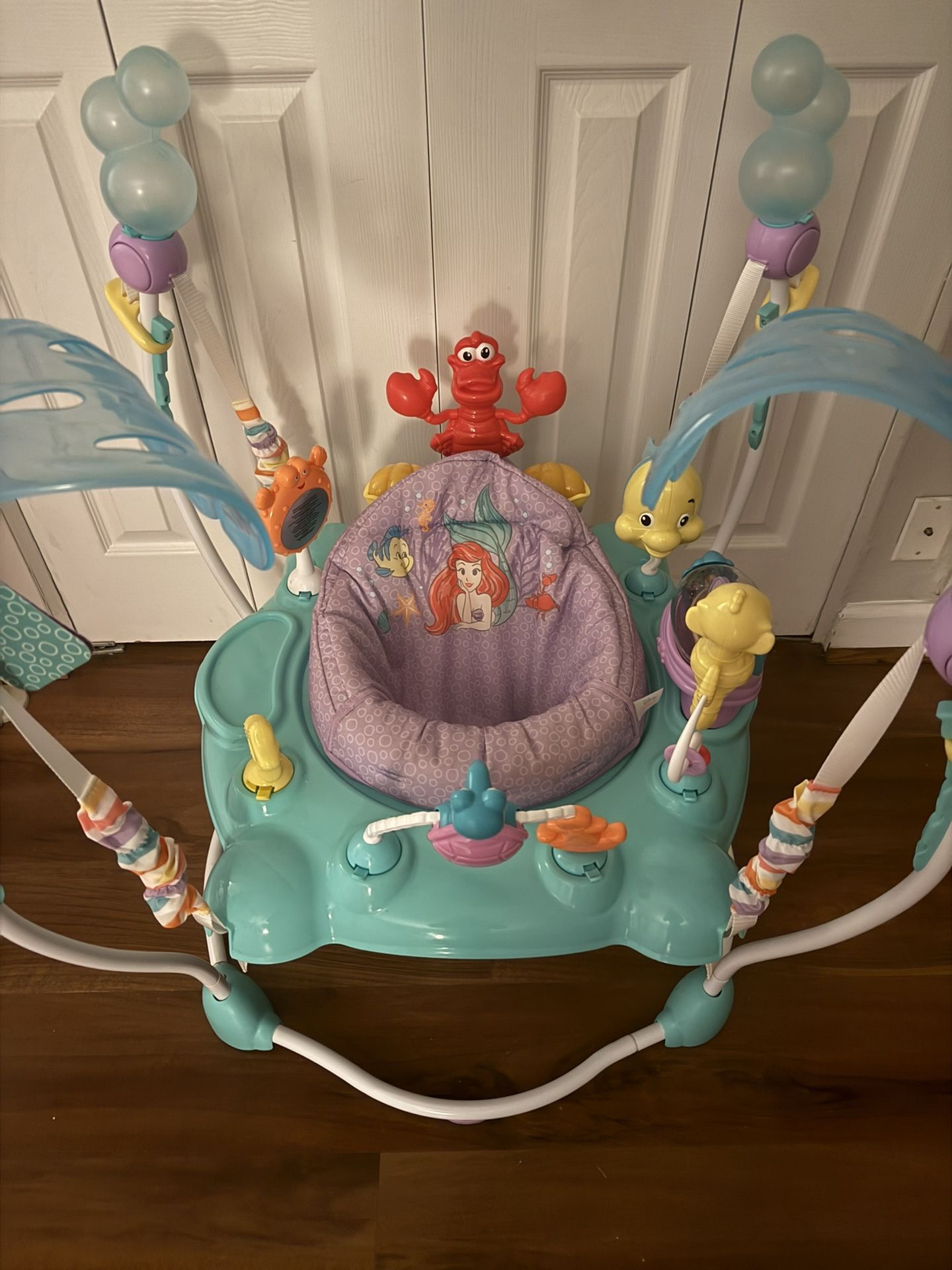 The Little Mermaid Sea of Activities Baby Activity Jumper with Interactive Toys, Lights & Music with Disney Princess Ariel, 6-12 Months (Blue)