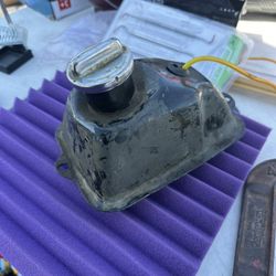 small, black metal fuel tank, similar to those used on ATVs, dirt bikes, or scooters