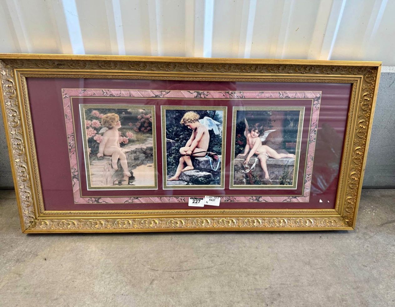 Vintage framed set of three prints featuring cherubic figures.