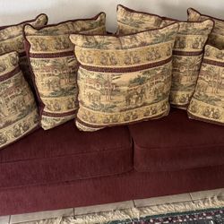 Burgundy  sofa and Loveseat decorated Custom tapestry-style throw pillowsi