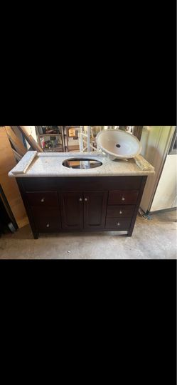 Used Wood Freestanding Bathroom Vanity Single Ceramic Sink Granite Countertop  Undermount ceramic sink 2 central doors, three drawers on each side  Al