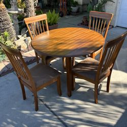 Brand New. Ashley round drop leaf Dining Table with 4 chairs.