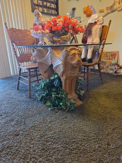 Lion table carved out of one piece of wood, 3 big lion heads. What if a kind, very heavy? Four chairs and a large, thick glass top, perfect