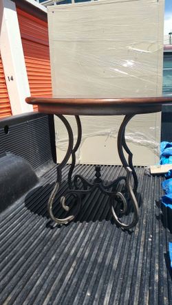 Maitland Smith wrought iron based table w/ wood top.