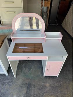 Small Pink Child makeup vanity table. Good condition measurements 17 deep x 32 x 20 h x ( 40 mirror).