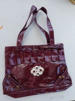 Maroon handbag with silver decoration