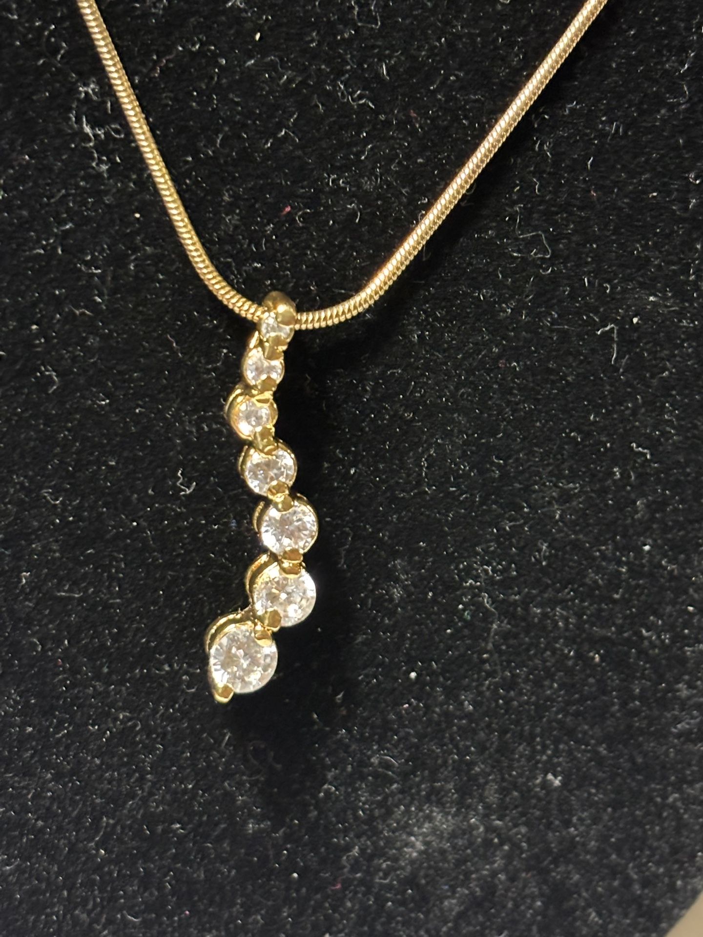 Gold Tone chain with a seven stone pendant