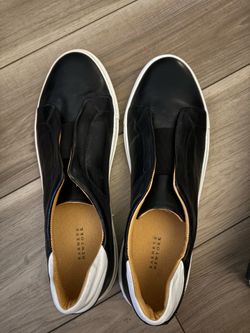 NEW Barneys New York black and white leather slip-on sneakers with elastic strap detailing.