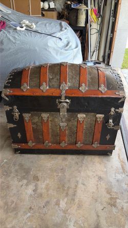 Vintage trunk with hinged lid and metal accents
