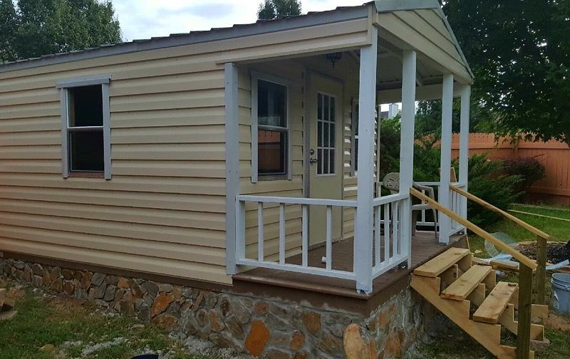 Storage SHED 12-ft wide & 16-ft long man cave with shelves, 4-windows & a front porch.