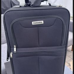 Black carry-on suitcase for sale — 23.5 x 13.5 x 8 inches.